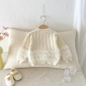 Detailed shot of infant cable knit sweater with cozy fuzzy cuffs and warm fabric.