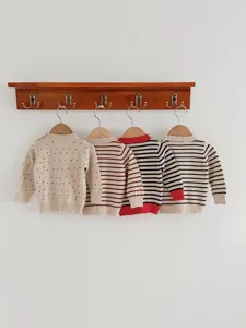 Baby gebreide trui detail met vier stuks met schattige stippen en klassieke strepen.