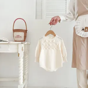Cute baby knit romper featuring vintage hollow-out design, hand-crafted bobbles, elegant beige style.