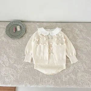 Detailed view of baby girl vintage knit cardigan and romper set with delicate hollow design.