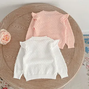 Detailed view of toddler girls knitted cardigan with ruffle sleeves, cute hollow out style.