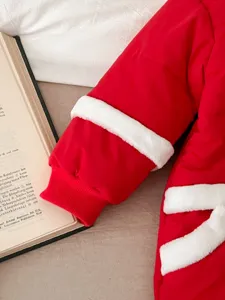 Red baby winter romper detail view, thick cotton crawler with white plush trim, cozy cold weather outfit.