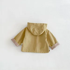 Detailed view of the baby hooded windbreaker back and checkered cuff design features.