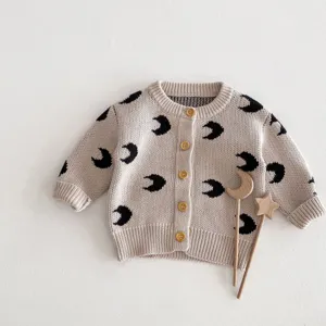 Baby knit cardigan featuring all-over moon pattern and cute wooden buttons for infants.