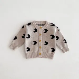 Infant baby knitted cardigan sweater detail view, cute moon pattern cotton knitwear top.