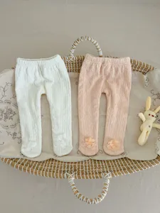 Baby fleece-lined footed tights with cute flower details, soft cotton winter wear.