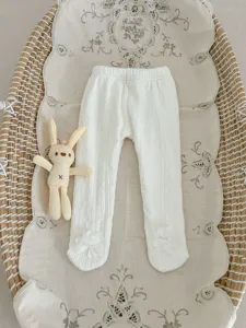 Cute baby toddler winter white footed thermal leggings with sweet flower details flat lay.