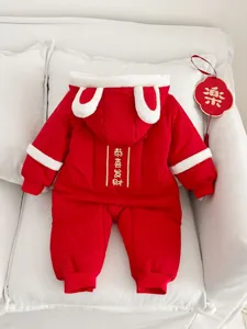 Red baby winter romper detail, cute rabbit ears hood and festive New Year design.
