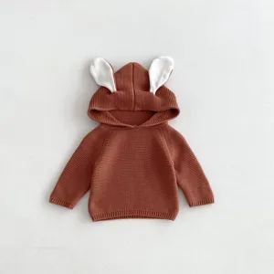 Close-up details of the cute brown knitted baby hoodie featuring adorable white bunny ears design.