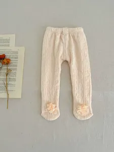 Cozy baby girl cable-knit footed tights in soft peach pink with cute chiffon flowers.