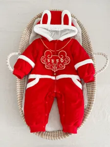 Close-up detail of a red baby winter jumpsuit with cute rabbit ears and festive embroidery.