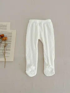 Cozy fleece-lined baby toddler tights in crisp white with sweet floral foot accents.