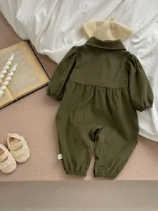 Detailed view of a baby girl green corduroy floral long sleeve romper with collar and cute cuffs.