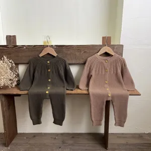 Detailed view of the baby knitted long sleeve romper with button closure in two chic colors.