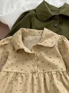 Cute corduroy baby romper featuring floral print, lapel collar, and delicate buttons.