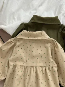 Detailed view of baby corduroy floral romper, lapel collar and long sleeves for infants.