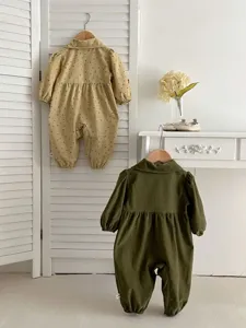 Baby romper detail view, featuring cute lapel collar, small floral print and long sleeves.