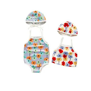 Toddler girls floral print swimsuit and cute matching swim cap set for summer beach.