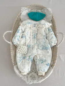 Detailed view of winter baby padded floral romper set with lace collar and matching accessories.