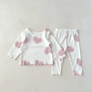 Infant ribbed cotton long-sleeve top and pants set with cute heart prints and lettuce hem.