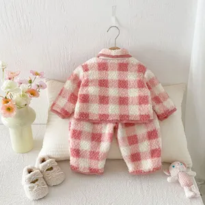 Toddler girls winter fleece-lined plaid pajama set, cozy padded two-piece lounge wear detail.