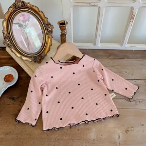 Pink long sleeve ribbed cotton toddler t-shirt with black polka dots and cute lettuce edge details.