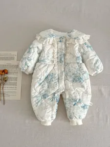 Close-up of baby winter quilted floral romper with delicate ruffled collar and buttons.