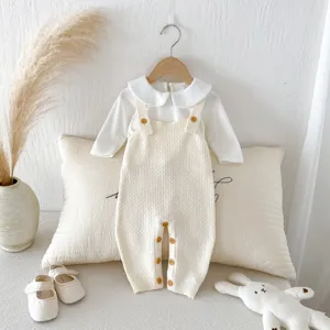 Cute baby knitted overalls set with long sleeve shirt and matching infant shoes.