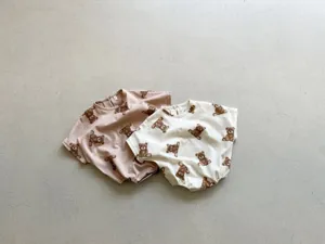 Baby romper detail featuring all-over cute teddy bear print, soft cotton fabric, short sleeves.