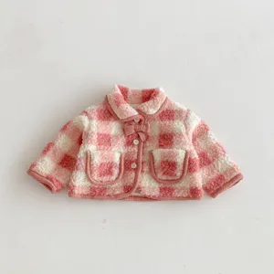 Pink and white checkered plush baby girl winter warm jacket detail with cute bow and buttons.