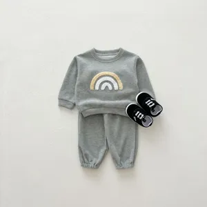 Grey baby sweatshirt set detail showing cute textured rainbow embroidery and soft cotton fabric.