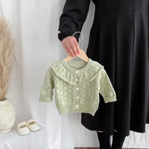 Light green baby girl hollow knit cardigan detail featuring a charming large ruffle collar.