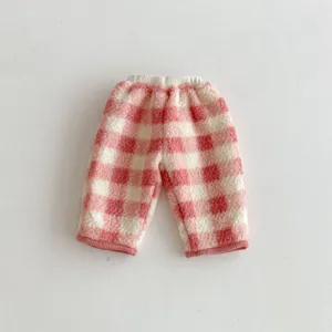 Detailed shot of cute pink and white plaid fleece baby pants with soft sherpa lining.