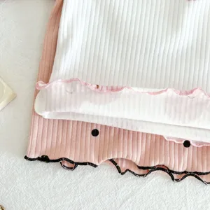 Infant ribbed cotton sleepwear detail view, comfortable long-sleeve toddler home wear set.