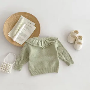 Detail view of baby girl knit sweater, sage green ruffled collar hollow out long sleeve top