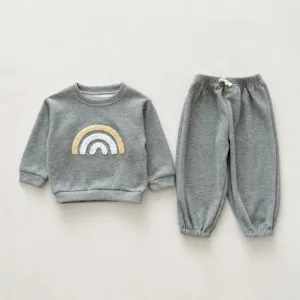 Grey baby sweatshirt and pants detail, cute rainbow patch, cozy cotton casual two-piece.