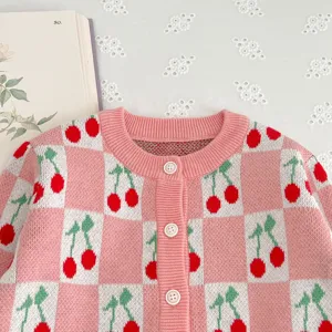 Baby pink cherry knit cardigan detail shot, cute infant checkered knitwear sweater.