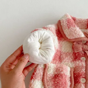 Close-up view of the pink and white plaid toddler girl fleece winter coat detail.