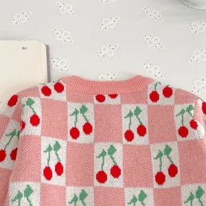 Infant baby girl knit cardigan detail, pink white checkered pattern with cute sweet cherry design.