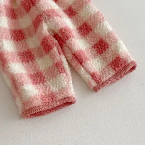 Detailed view of pink and white checkered fleece fabric for kids winter clothing, soft and warm.