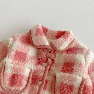 Pink white plaid toddler winter coat detail, cozy fuzzy sherpa fabric with cute bow trim.