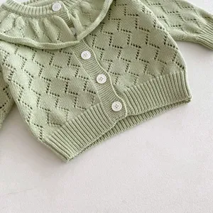 Baby girl knit cardigan detail, light green hollow-out cotton sweater with ruffle collar.
