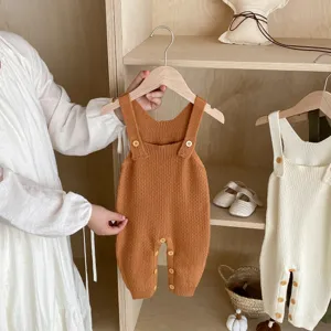 Detailed closeup shot of the soft knitted baby romper, highlighting texture and buttons.