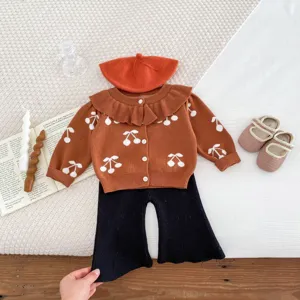 Toddler girl knit cardigan cherry pattern outfit detail view, charming autumn fashion style.