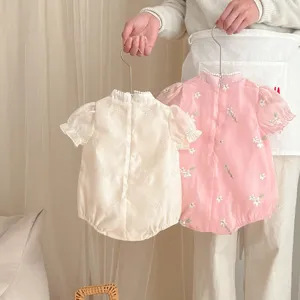 Detailed view of summer baby girl cute cheongsam style romper with floral embroidery.