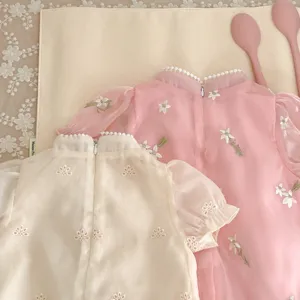 Detailed view of summer baby girl floral embroidered romper, cute vintage style romper.