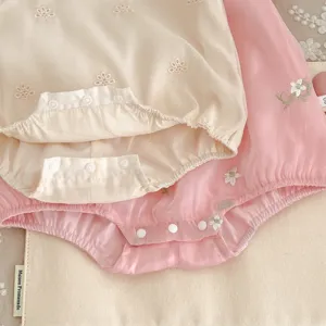 Detailed close-up view of summer baby toddler girl cotton floral embroidered bodysuit cute rompers.