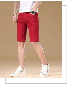 Detailed shot of red denim shorts for men, casual five-quarter pants showing cotton texture.