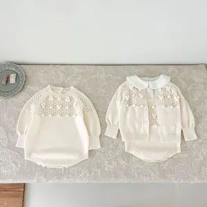 Close-up of sweet baby knitwear set with hollow-out design, delicate crochet balls, and retro style.