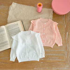Detailed view of toddler girls knit cardigan sweaters, hollow out design with cute ruffles.